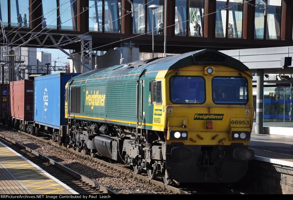 A Class 66 leads an outbound container train through the station